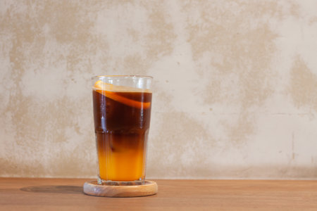 Glass of americano mixed with orange juice, stock photoの写真素材