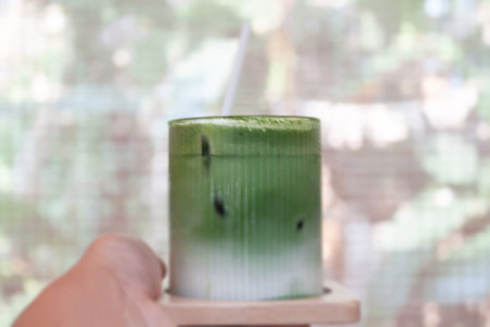 Hand holding iced matcha greentea, stock photo