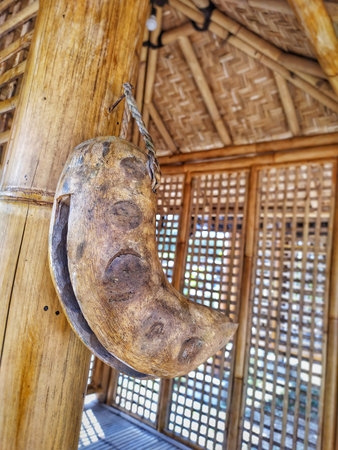 Traditional japanese wooden doll hanging on the wall of a house.の写真素材
