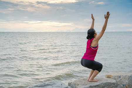 Woman yoga at beach