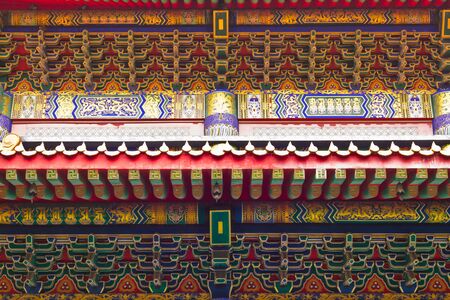 Beautiful buddhistic artwork on the roof of a templeの写真素材