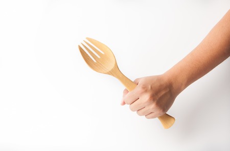 Hand holder wooden fork, white background.の写真素材