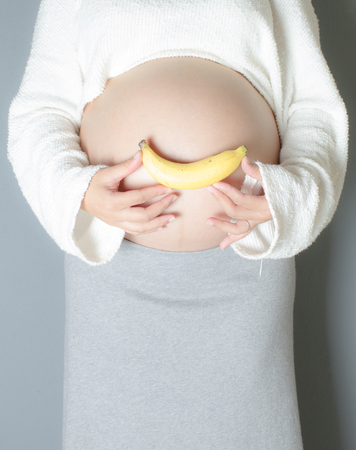 Belly of a pregnant woman with smileの写真素材
