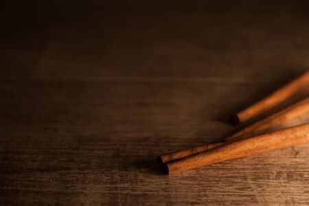 Cinnamon on wooden background. Macro photography. Vintage style.の写真素材