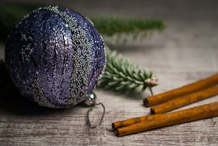 Christmas decoration. Cristmas background with ball and cinnamon. Detailed photography.
