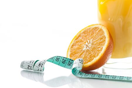 Fresh orange juice on white background with orange and centimeter.の写真素材