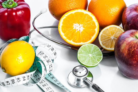 Fitness concept with fruit, centimeter and stethoscope. Fitness motivation.の写真素材