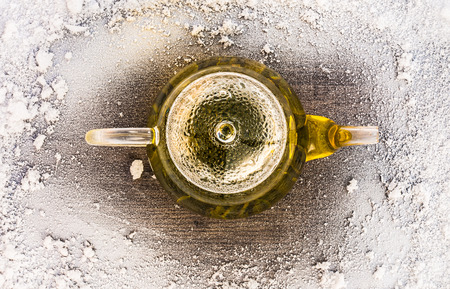 Tea with snow on wooden background table. Top of view.の写真素材
