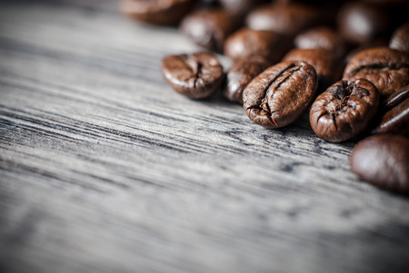 Coffee beans concept on wooden table background. Close up macro photography.の写真素材
