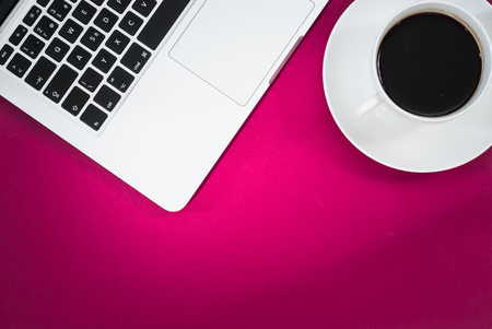 Business workspace concept. Top view. Pink workspace concept with laptop and coffee.の写真素材