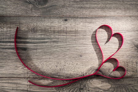 Valentines day celebration concept on wooden background table. Two ribbon hearths. Top view.の写真素材