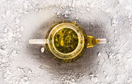 Tea with snow on wooden background table. Top of view.の写真素材