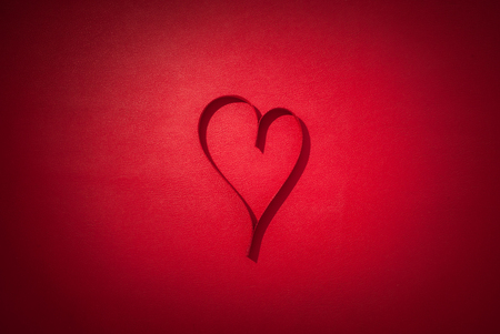 Valentines day celebration concept background. Red valentines day card concept with ribbon hearths.の写真素材
