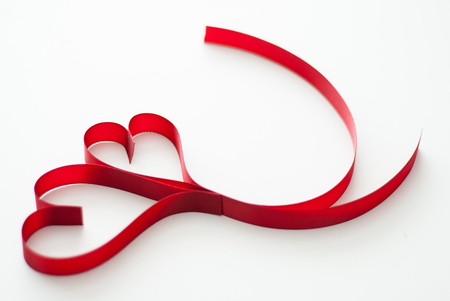 Valentines day celebration concept background. Red ribbon hearths on white background isolated.の写真素材