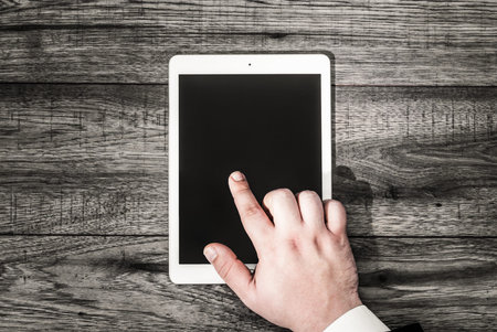 Business workspace concept. Top view. Workplace with tablet and coffee. Business man hand.