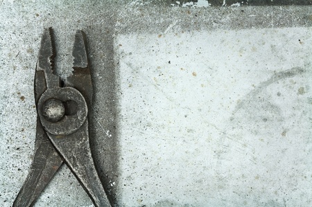Old rusty pliers on metal background の写真素材