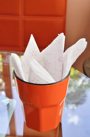 tissue in cup on glass tableの写真素材