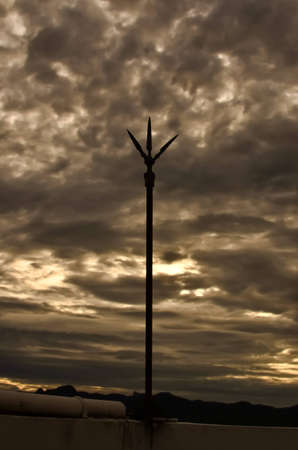 lightning rod and cloudy sky at sunsetの写真素材