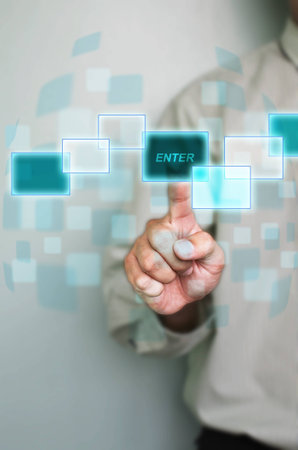 hand of business man pushing enter button on a touch screen interface 