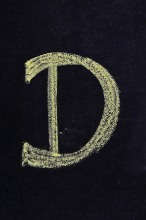 text "D" written on blackboardの写真素材