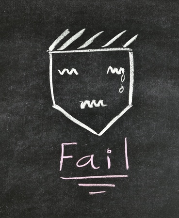 fail and unhappy face written on blackboardの写真素材
