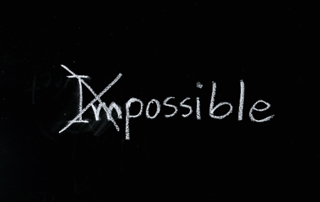 Change the word impossible to possible on blackboard.の写真素材