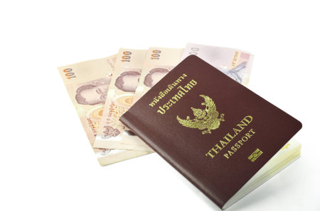 Thailand passport and banknote on white background の写真素材
