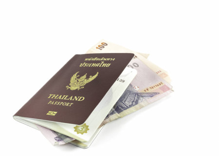 Thailand passport and banknote on white background の写真素材