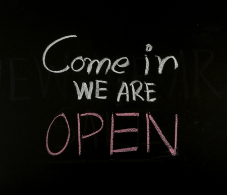 writing come in we are open on blackboardの写真素材