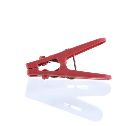 red plastic cloth peg and reflection on a white background. の写真素材