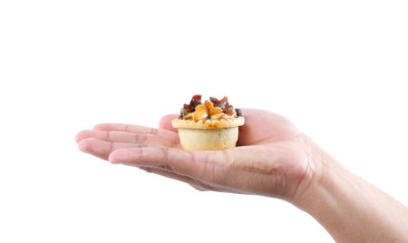 hand holding fruit tarts on white backgroundの写真素材