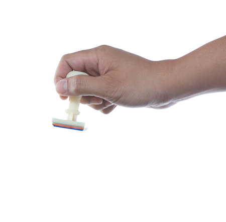 hand holding rubber stamp on white backgroundの写真素材