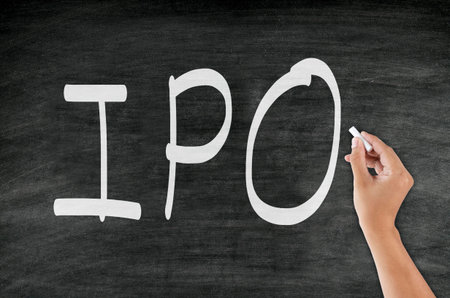 handwriting âIPOâ with chalk on blackboardの写真素材