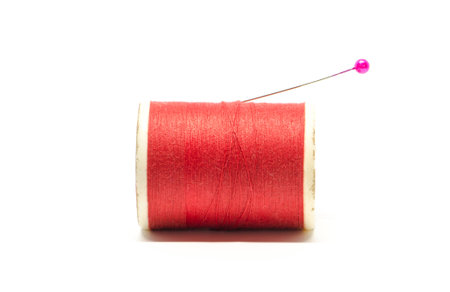 Spool of thread with needle on white backgroundの写真素材