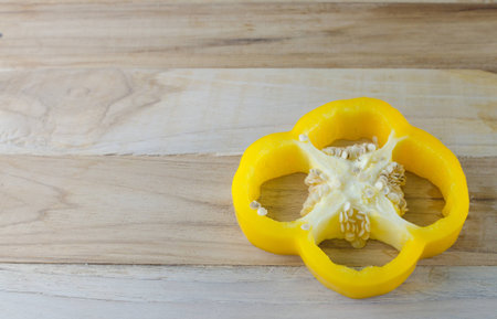 yellow bell pepper on wooden table with copyspace