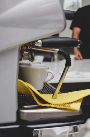 Professional coffee machine making two coffeesの写真素材