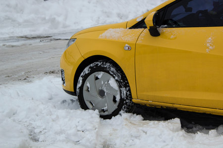 Parked car under snow cover. Winter parking copy space background
