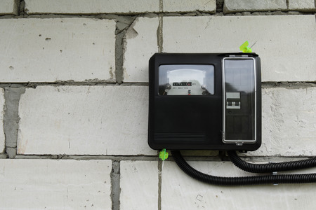 Electricity meter for use outdoors appliance, modern technology to monitor the home's electrical energy consumption.の写真素材