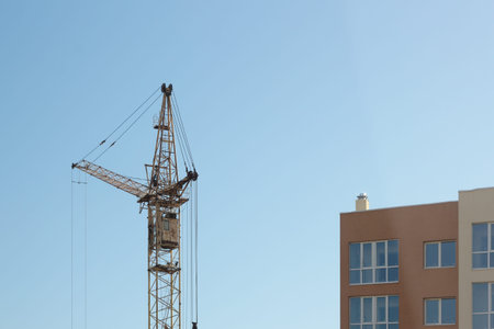 Industrial construction building crane against blue sky in background