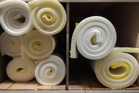 Rolls white and yellow foam rubber building material texture.の写真素材