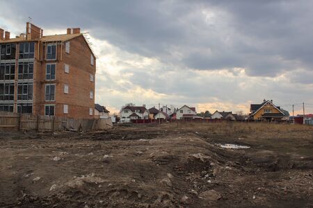Construction of unfinished residential house against private houses in backgroundの写真素材