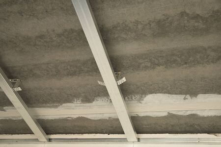 Drywall installation work in progress by construction workers at the construction site.の写真素材