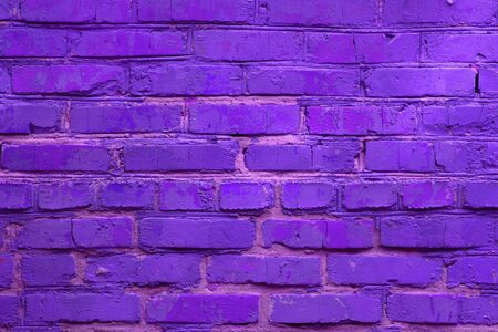 Neon colored brick wall background. Horizontal toned backdrop.の写真素材