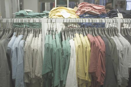 Blurred Bokeh Image of a garment with hanging apparel for backgroundの写真素材