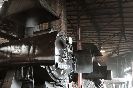 Old steam locomotive in a round houseのeditorial素材