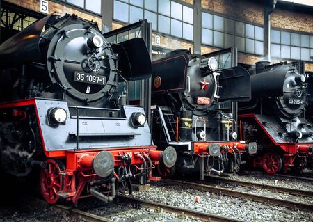 Old vintage steam locomotive in a depotの写真素材