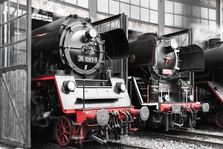 Old vintage steam locomotive in a depotの写真素材
