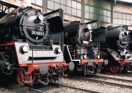 Old vintage steam locomotive in a depotの写真素材