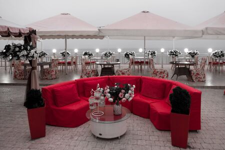 Red couch in a beach bar in the eveningの写真素材