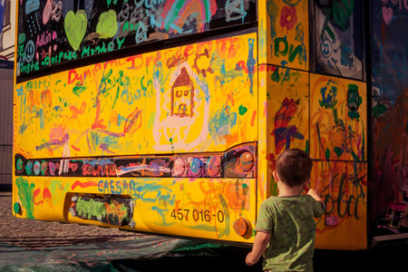A kid is coloring a bus
